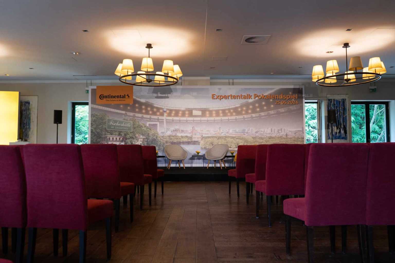 Festsaal mit Reihenbestuhlung, Bühne und Präsentationsbereich für Tagungen und Events.